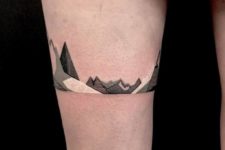 Black, gray and white tattoo on the leg