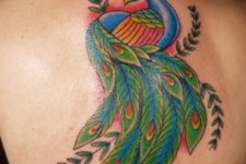 Blue, green and red tattoo on the back