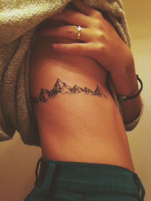 Gorgeous mountain tattoo on the right side