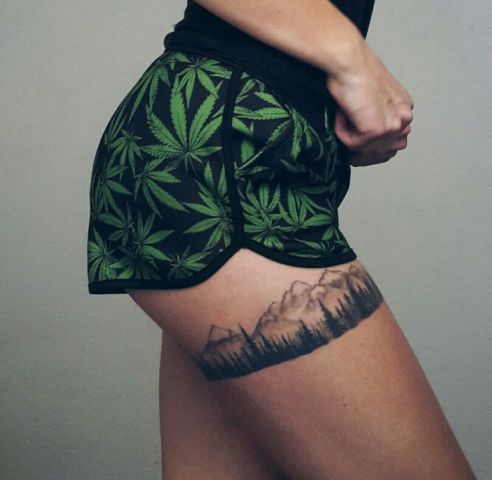 Mountain and trees tattoo on the leg