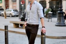 With light gray button down shirt and dark brown pants