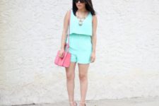 With pink bag, nude heels and statement necklace