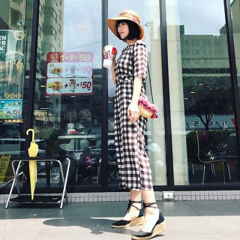 With straw hat, floral bag and black lace up sandals