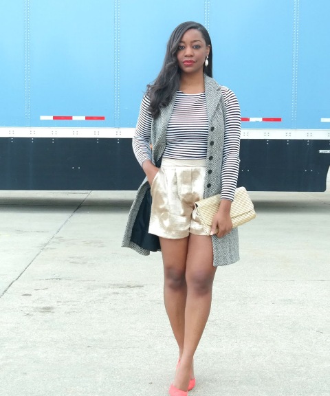 With striped shirt, gray vest, clutch and pink pumps