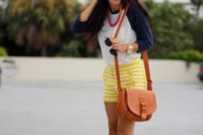 With white and navy blue shirt, yellow striped shorts and orange bag