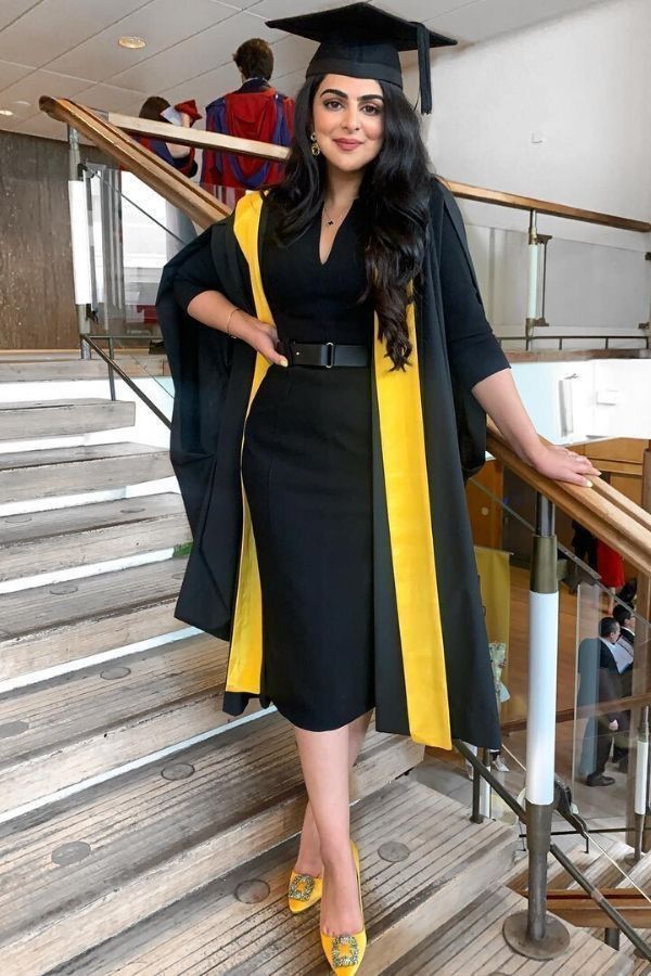 a black short sleeve midi dress, a black belt, a black and godl robe, gold buckle shoes and a hat are a gorgeous ensemble