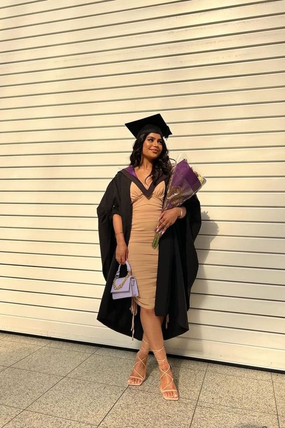 a tan draped midi dress, a black robe, a hat and nude lace up shoes are a cool combo for graduation