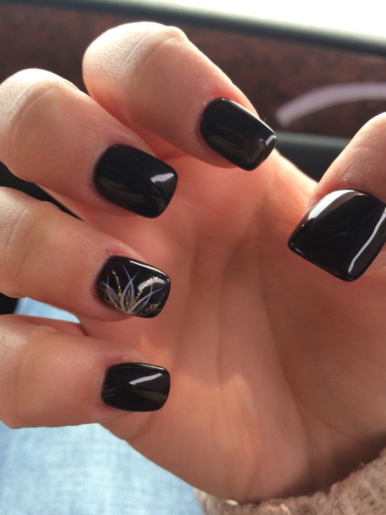 black manicure with a gold and silver glitter accent nail