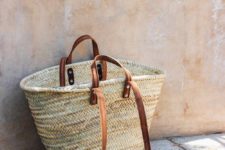 06 a straw tote bag with brown handles is summer and beach classics