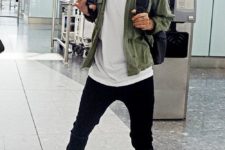 06 black jeans, a white tee, blue sneakers, an olive green shirt and a backpack