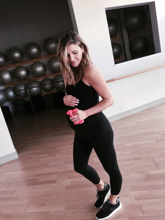 black leggings, a black spaghetti strap top and black chucks for an indoor workout