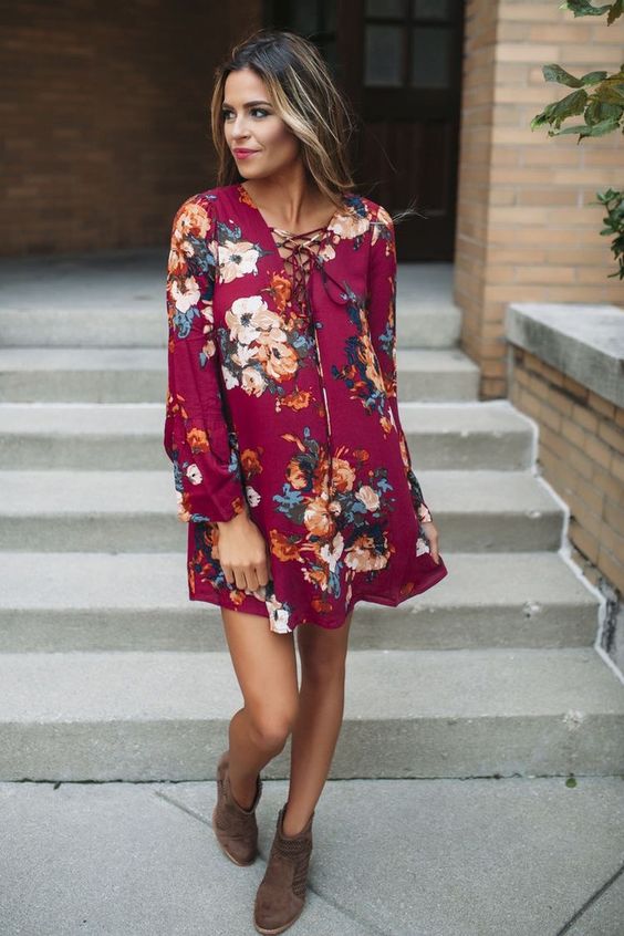fuchsia mini dress with lacing up, long sleeves and floral prints worn with brown ankle booties