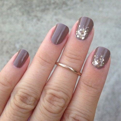 rounded taupe nails with gold glitter touches
