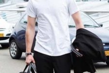 08 black pants, a white tee, white sneakers and a black bag to travel with style