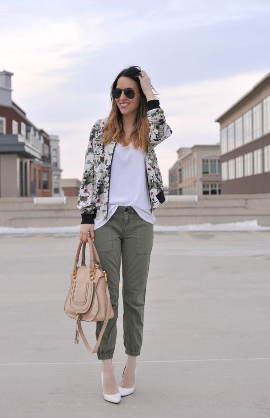 khaki pants, a white tee, a green floral print bomber jacket and white shoes
