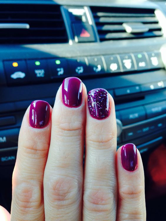 plum rounded nails with a glitter accent nail
