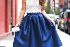 09 a white halter neckline lace crop top and a blue stain midi skirt, nude heels and a statement necklace