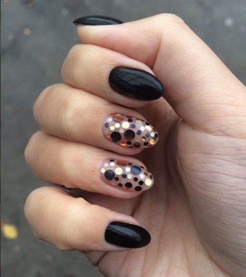 black rounded nails with accent polka dot nails in gold, copper and black