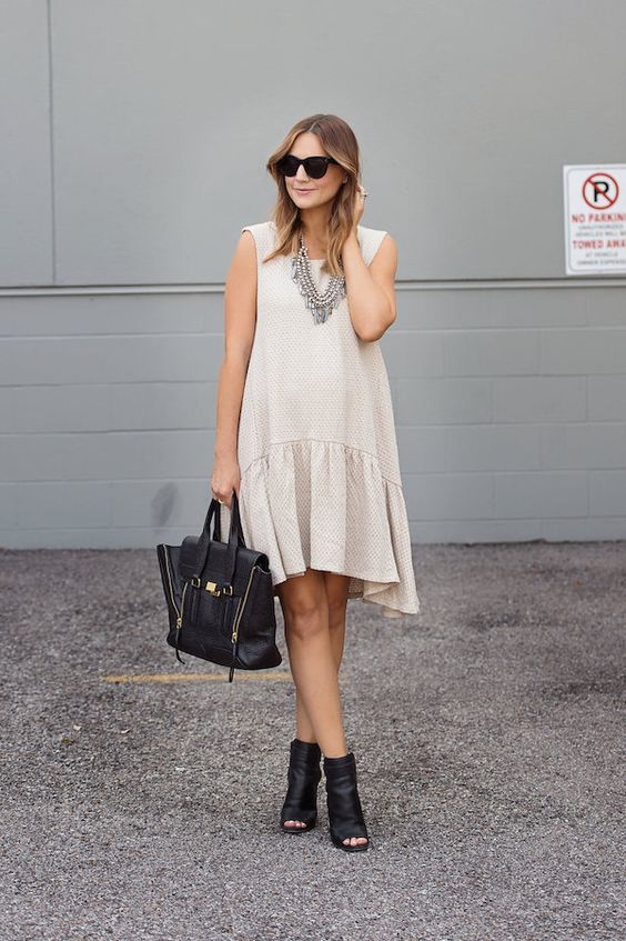 a neutral drop waist dress without sleeves, black leather peep toe booties and a matching tote