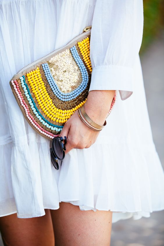 a half circle clutch with colorful beads and sequins is great for a neutral summer outfit