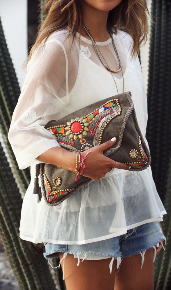 a large brown leather clutch with colorful beads and rhinestones for a boho look