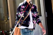 13 distressed jeans, a white shirt, a black floral print bomber jacket and a crossbody