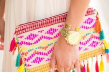 15 an embroidered bold clutch with bold tassels is ideal for a summer outfit