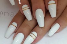 21 white nails with gold stripes look modern and elegant