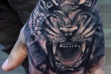 Angry tiger tattoo on the hand