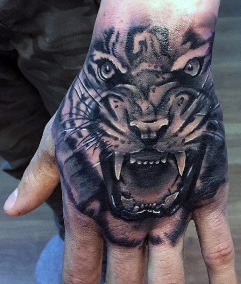 Angry tiger tattoo on the hand