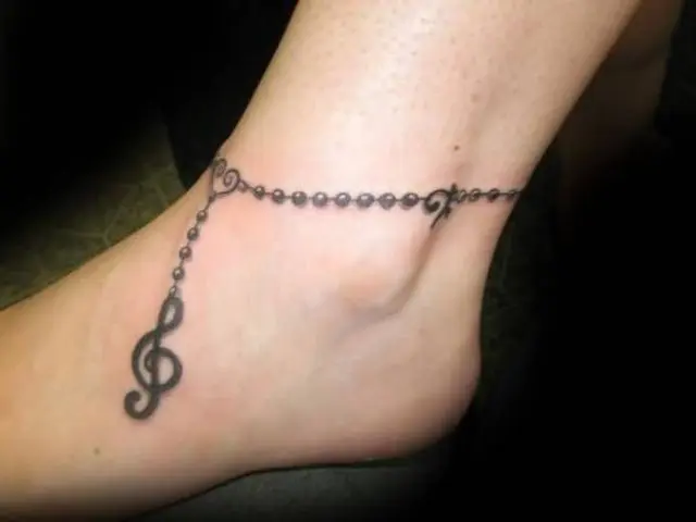 Ankle tattoo with treble clef