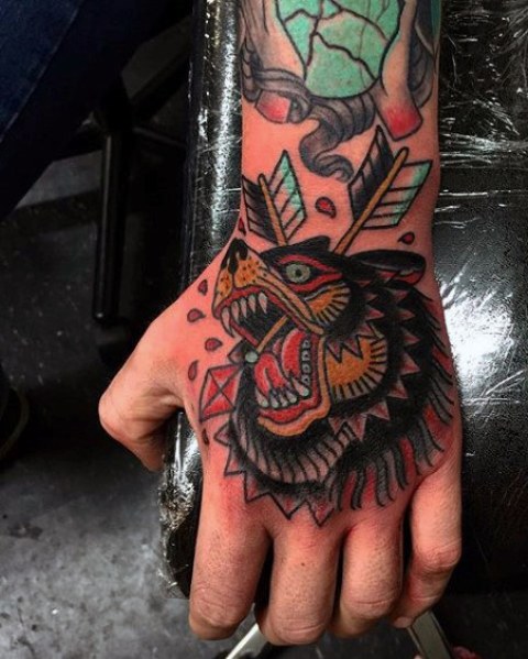 Bear and arrow tattoo on the hand