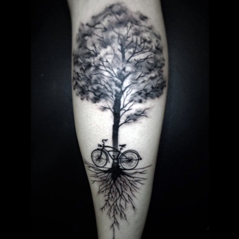 Bicycle and tree tattoo on the leg