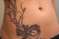 Black-contour tattoo on the stomach