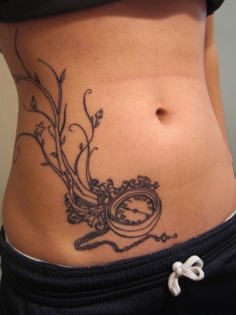 Black contour tattoo on the stomach