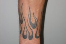 Black flame tattoo on the wrist