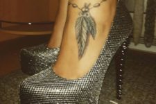 Black tattoo with feathers