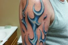 Blue flame tattoo on the arm