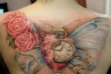 Clock and butterfly wings tattoo on the back