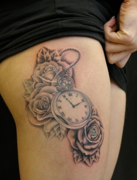 Clock with flowers tattoo on the leg