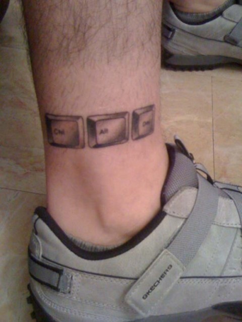 Computer keys tattoo on the ankle