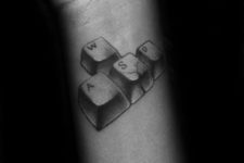 Computer keys tattoo on the wrist