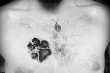 Dog paw tattoo on the chest