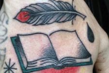 Feather and book tattoo