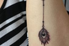 Feather with arrow tattoo