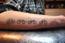 Five bicycles tattoo on the forearm