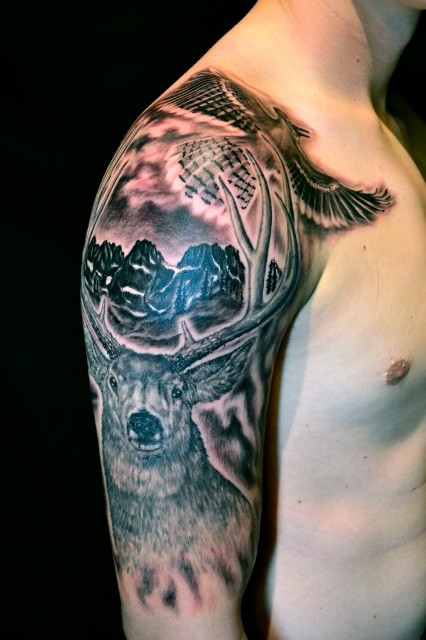 Half-sleeve tattoo with deer and bird