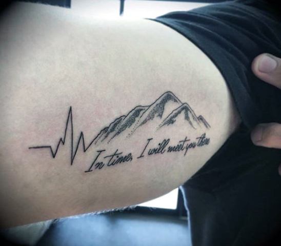 Heartbeat with black-contour mountain tattoo