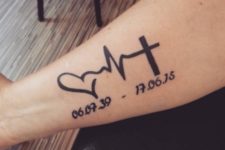 Heartbeat with heart and cross tattoo on the arm