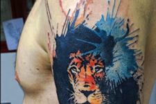 Lion with blue splashes tattoo